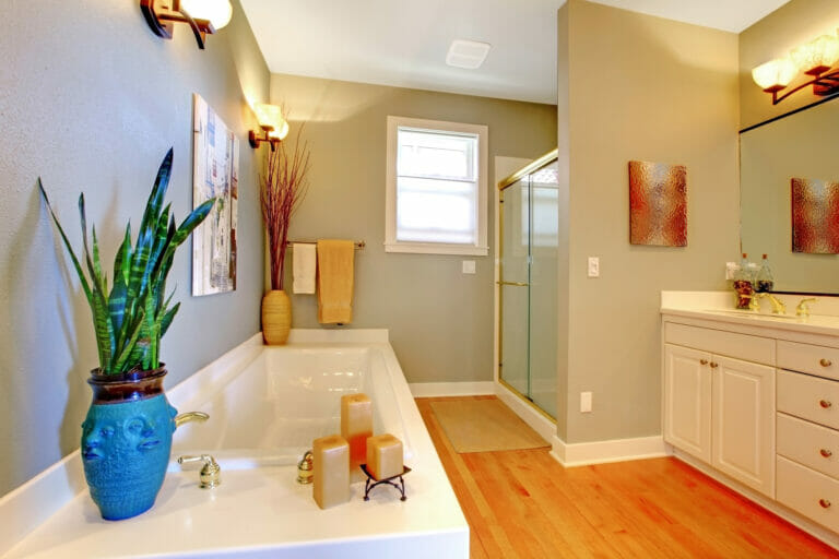 Large new remodeled bathroom with green walls and tub.